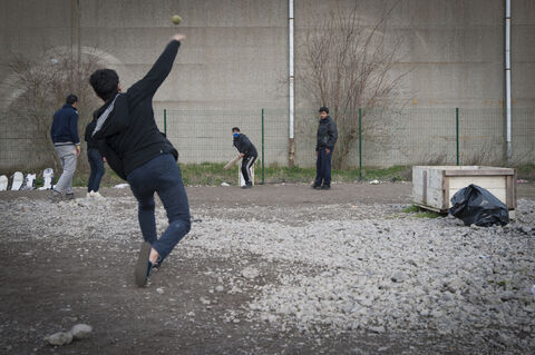  The Grande Synthe camp, the only humanitarian camp in France, a few days from the first year of its opening (March 7, 2017). Open following the closure of the Jungle in Calais to welcome migrants. A group of men playing cricket. Grande Synthe. France.2017