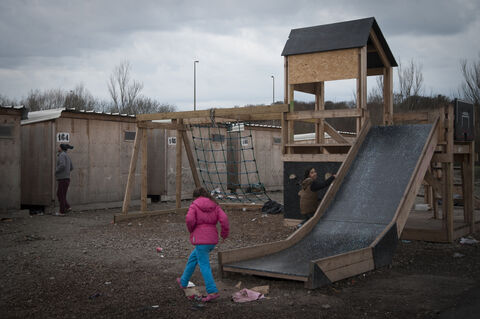  The Grande Synthe camp, the only humanitarian camp in France, a few days from the first year of its opening (March 7, 2017). Open following the closure of the Jungle in Calais to welcome migrants. Young kids on the kids playground of the camp. Grande Synthe. France.2017.